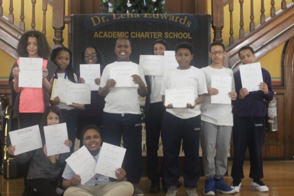 Fifth-grade students hold their certificates very proudly. 
